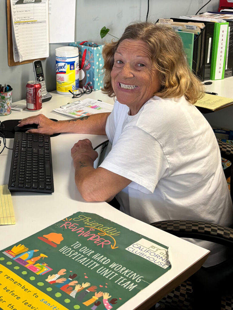 aspire house member at a computer work desk