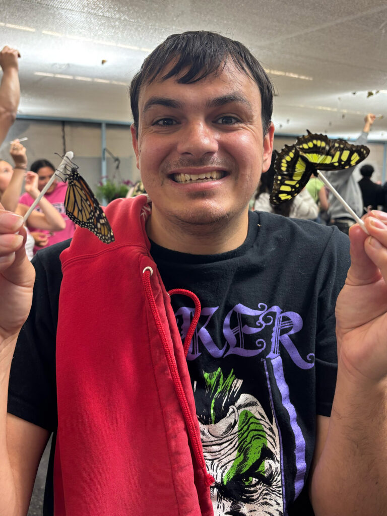 aspire house member holding butterflies